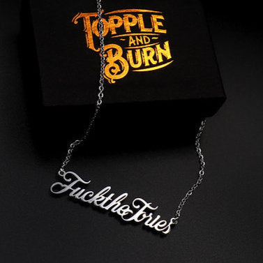 A ‘Fuck The Tories’ necklace by Topple & Burn – bold political jewellery available in rose gold, yellow gold, and silver.