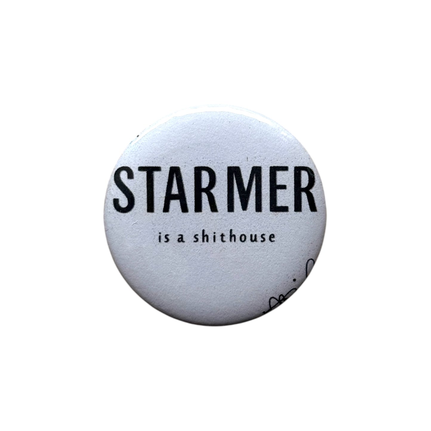 43mm round badge with black text reading “Starmer Is A Shithouse” – bold political message.